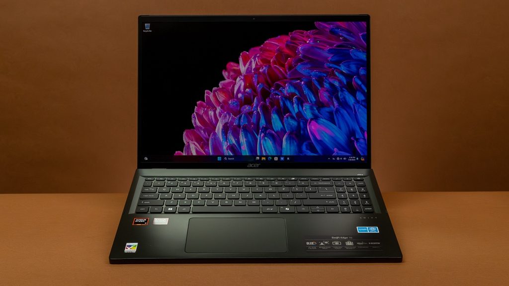 Extremely thin Acer Swift Edge 16-inch laptop open on a wooden desk.