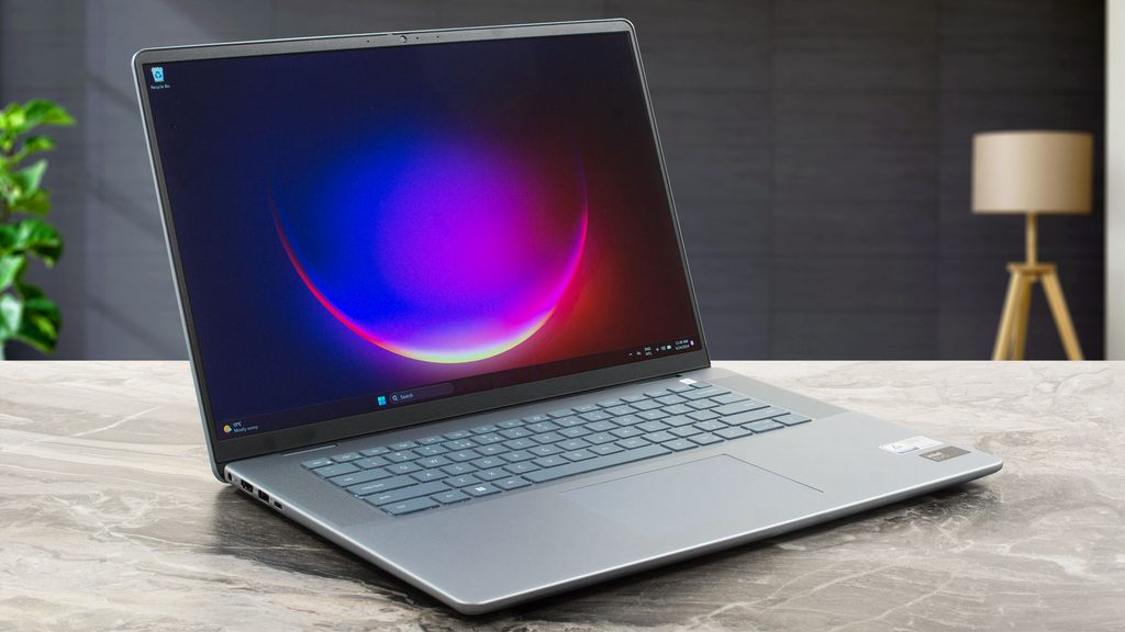 Silver Dell Inspiron 16 laptop sitting open on a table showcasing its wide 16:10 screen