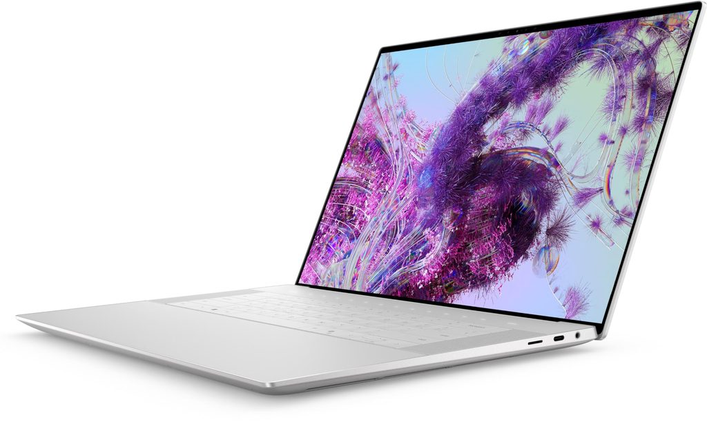 Silver Dell XPS 16 laptop standing open displaying colorful artwork on screen