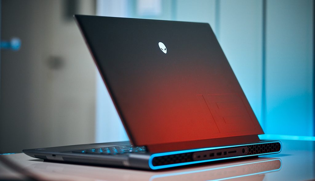 Silver and black Dell Alienware m18 gaming laptop open showcasing back vent RGB lighting
