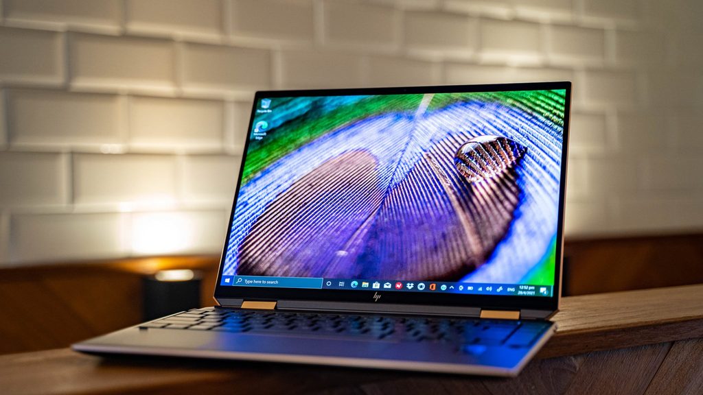 HP Spectre x360 14 convertible 2-in-1 laptop on a wooden surface