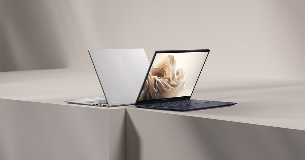 ASUS Zenbook 14 OLED laptop open on a clean desk surface, showing its thin profile and high-resolution screen.