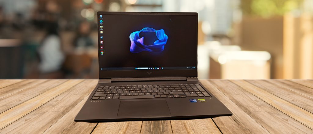 HP Victus 16 gaming laptop open on desk showing 16-inch screen