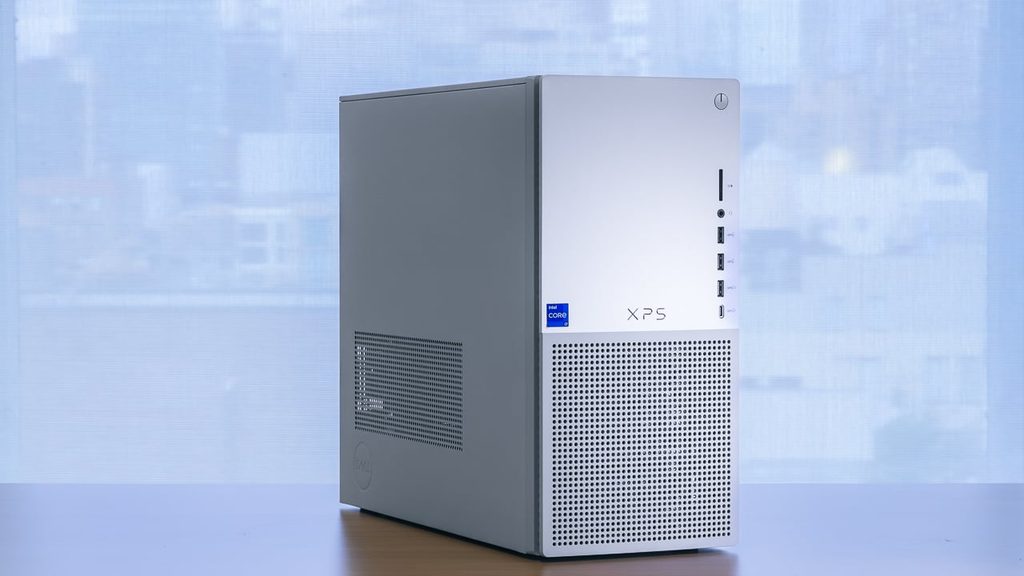 Silver Dell XPS Desktop tower standing on a wooden desk showing front mesh panel