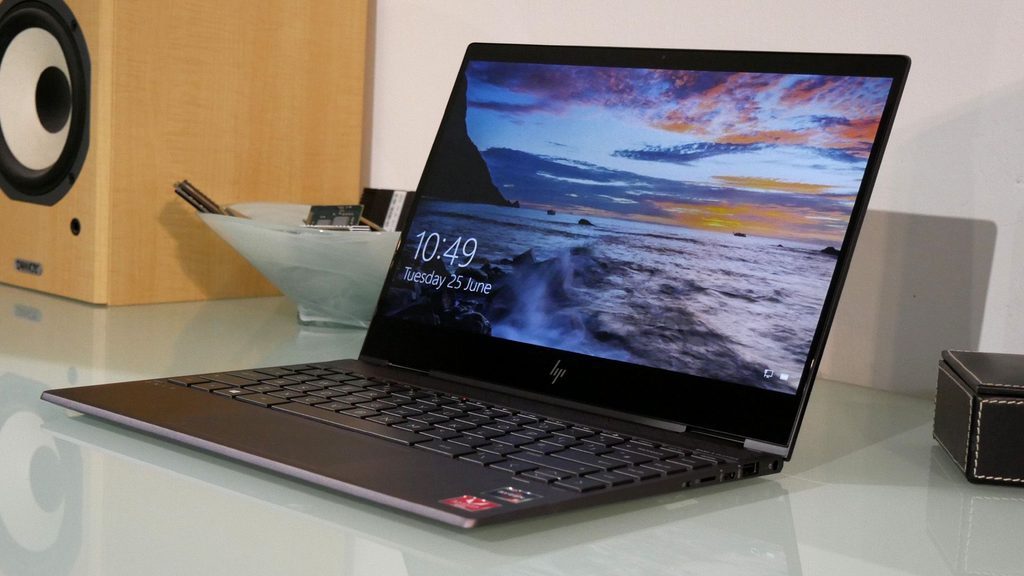HP ENVY x360 2-in-1 laptop flipped into tent mode on a desk.