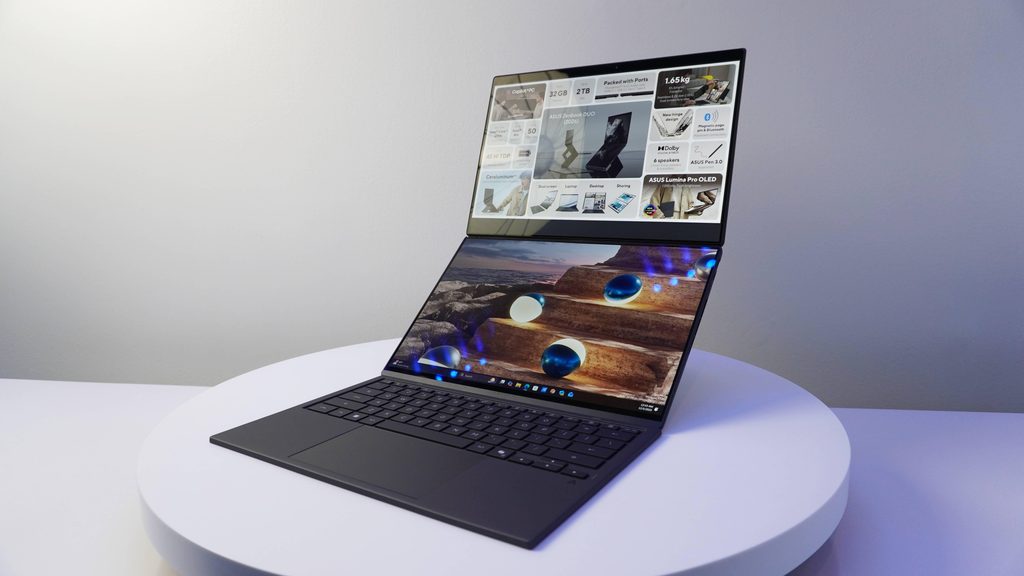 ASUS Zenbook DUO dual-screen OLED laptop setup vertically on a desk with kickstand.