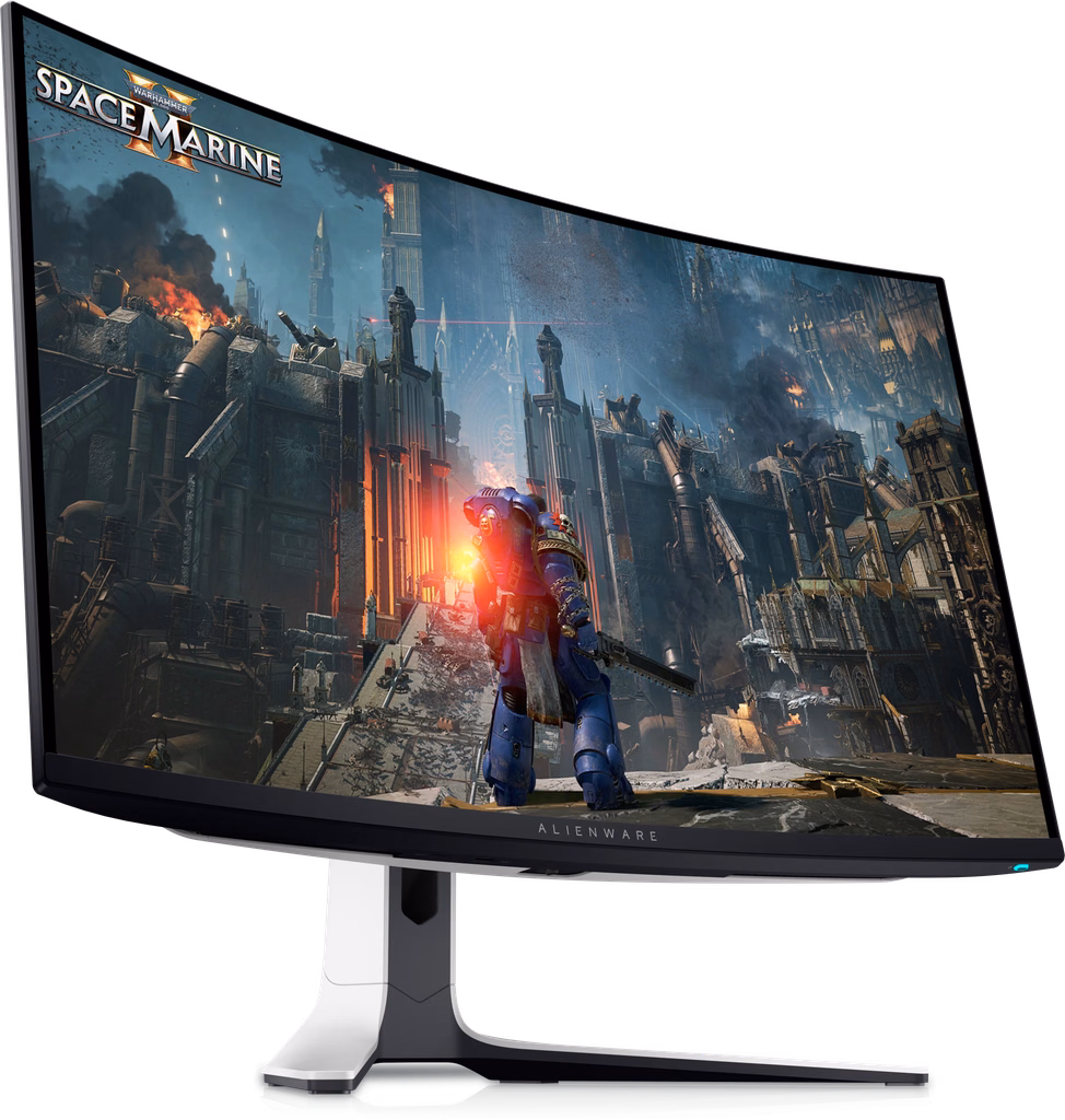 A Dell Alienware QD-OLED gaming monitor set up on a modern dark desk displaying vibrant RGB lighting